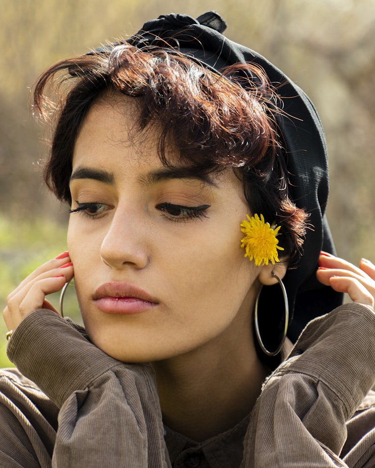 Silver hoop earrings for women on a light surface, close-up jewelry shot
