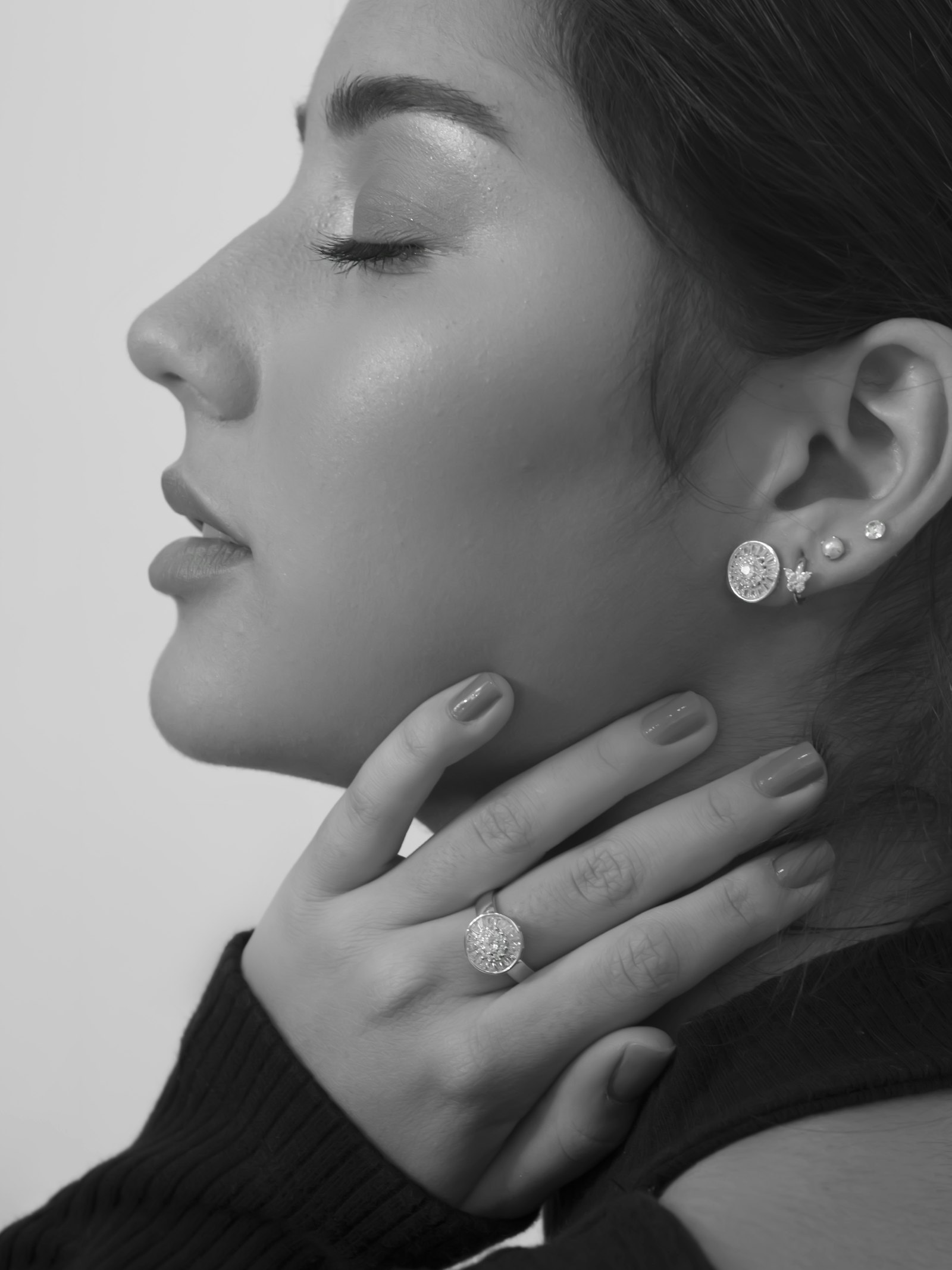 Titanium and metal piercing jewelry displayed on a light background